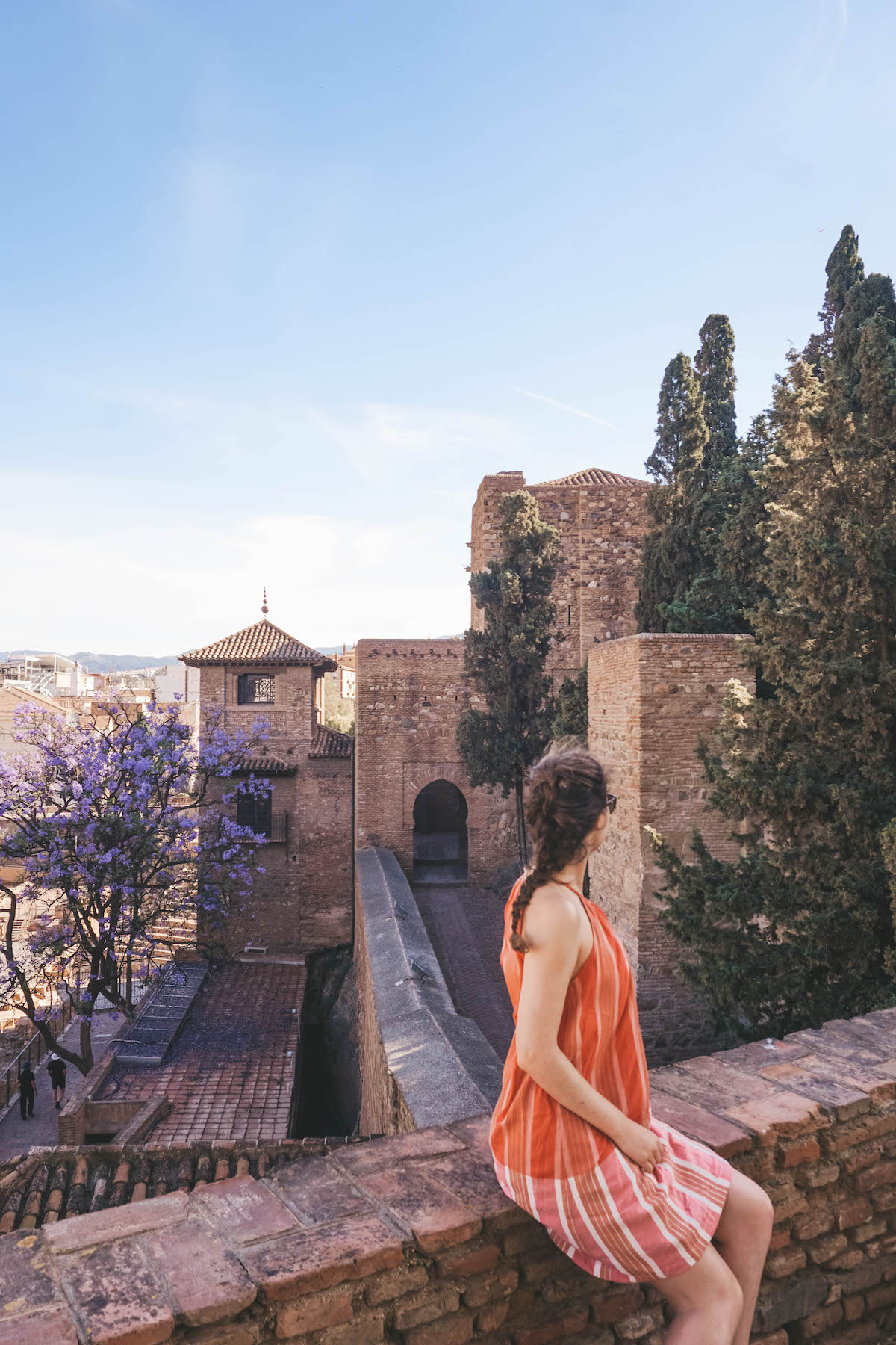 Woman looking out over the Alcazaba of Malaga. 