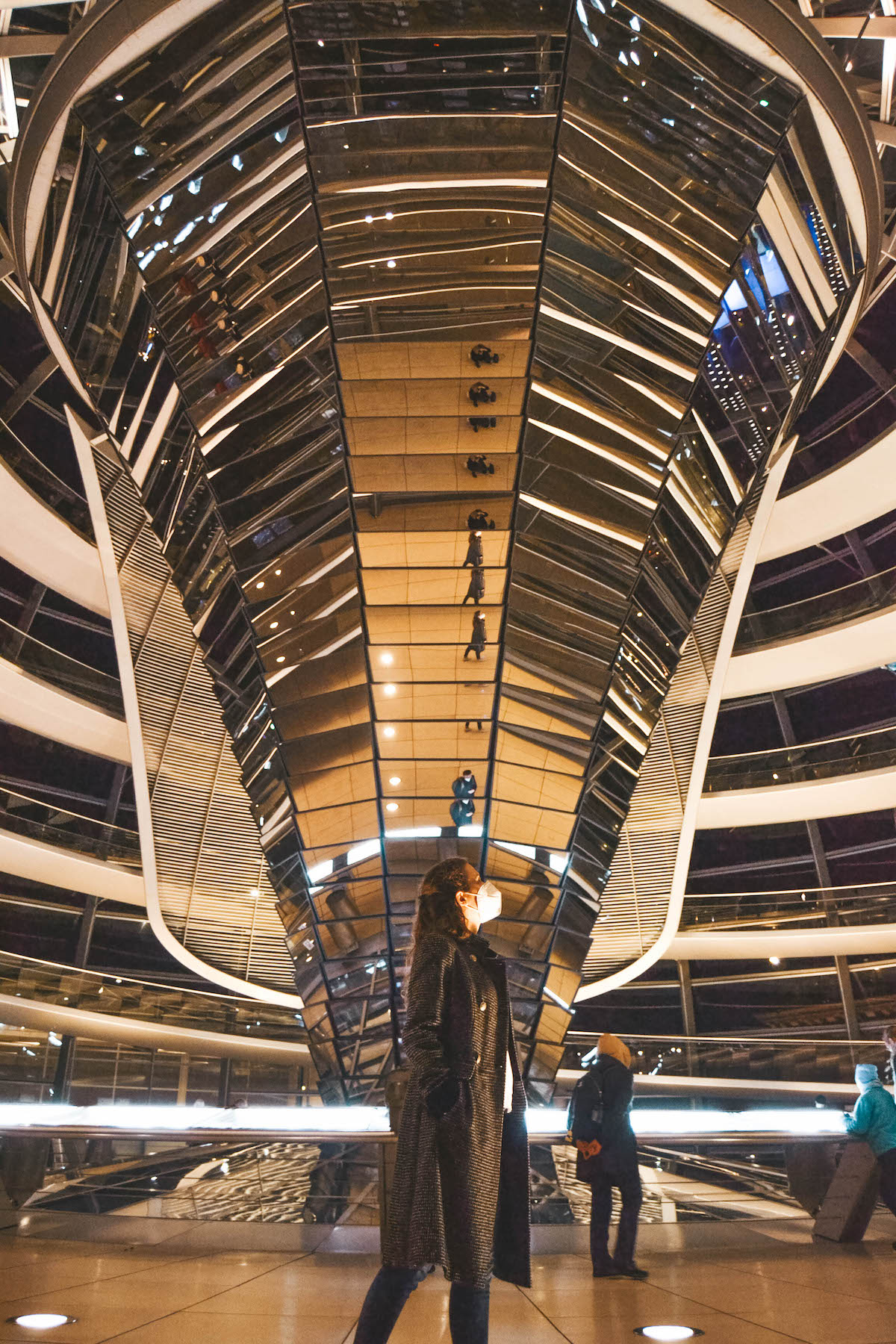 Woman standing inside the Berlin Reichstag at night. 