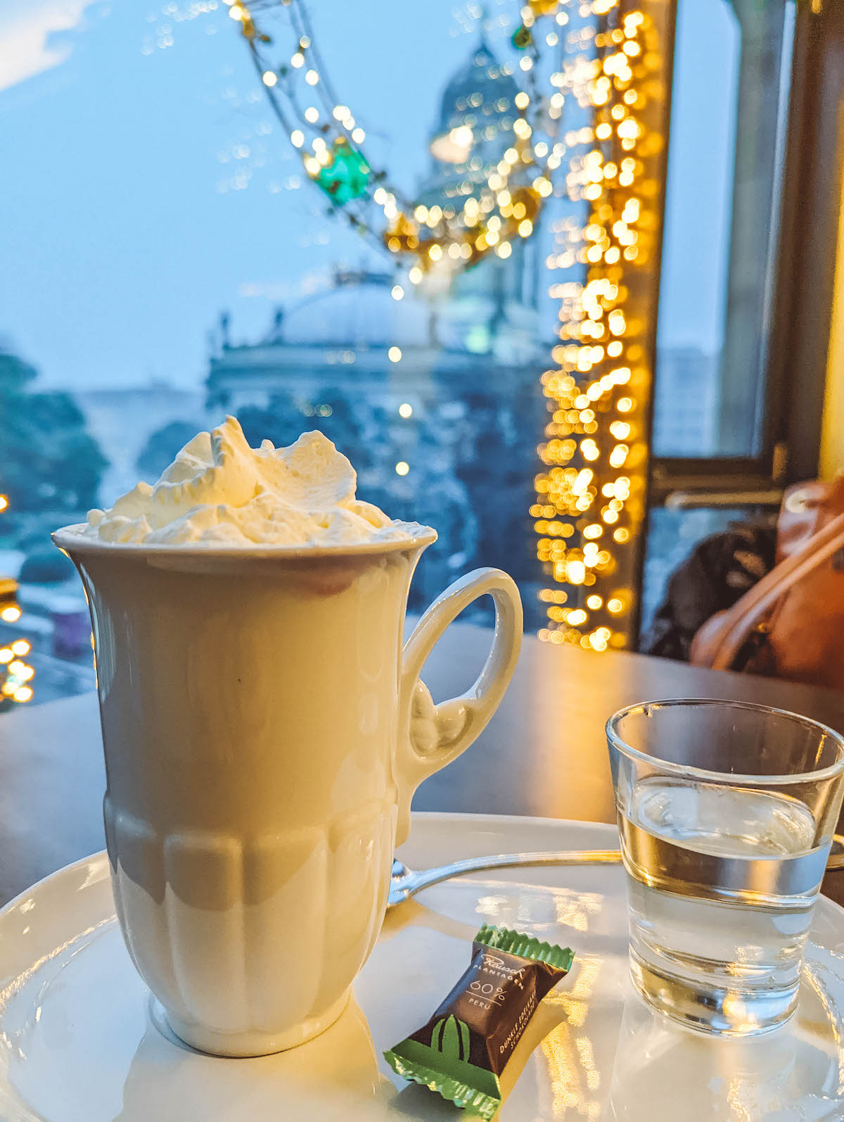 A hot chocolate at Rausch, with twinkle lights behind it.