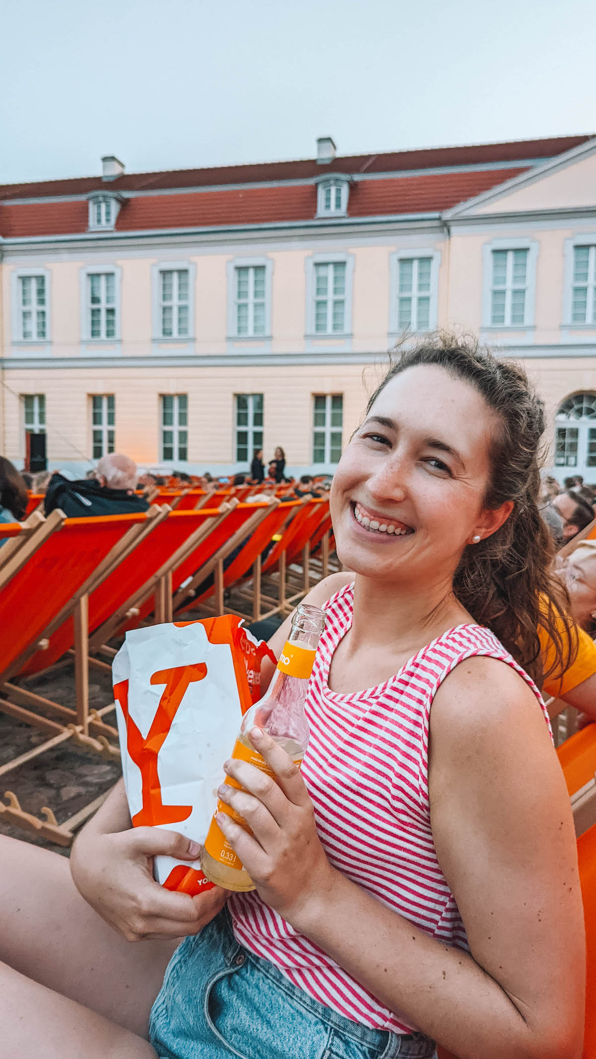 Woman smiling at Charlottenburg Palace open air cinema.