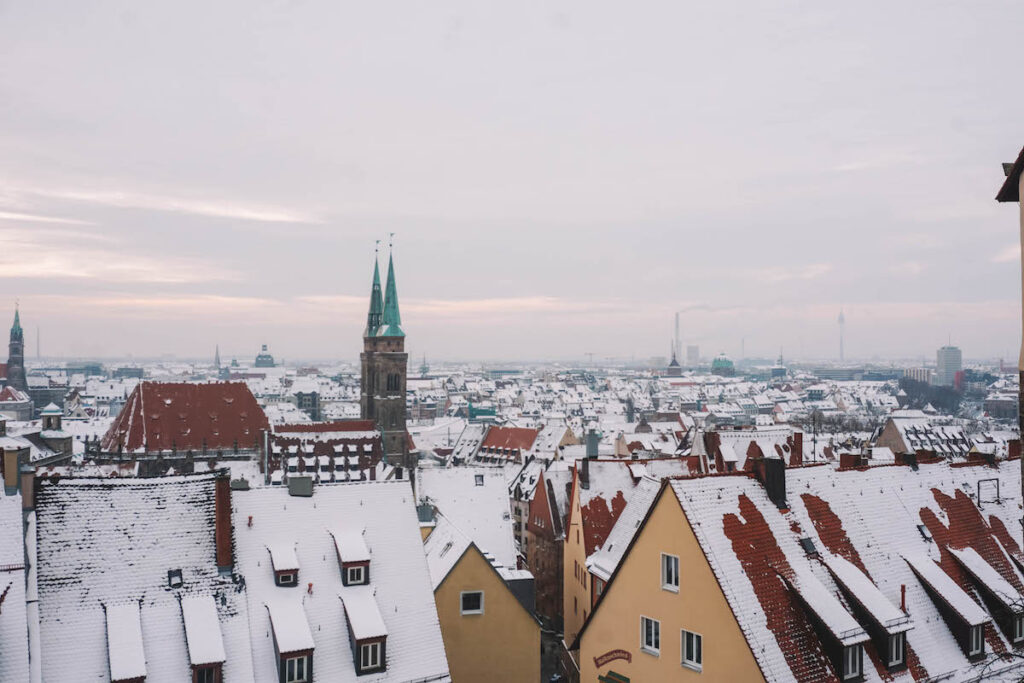 The skyline of Old Town Nuremberg, covered in snow.