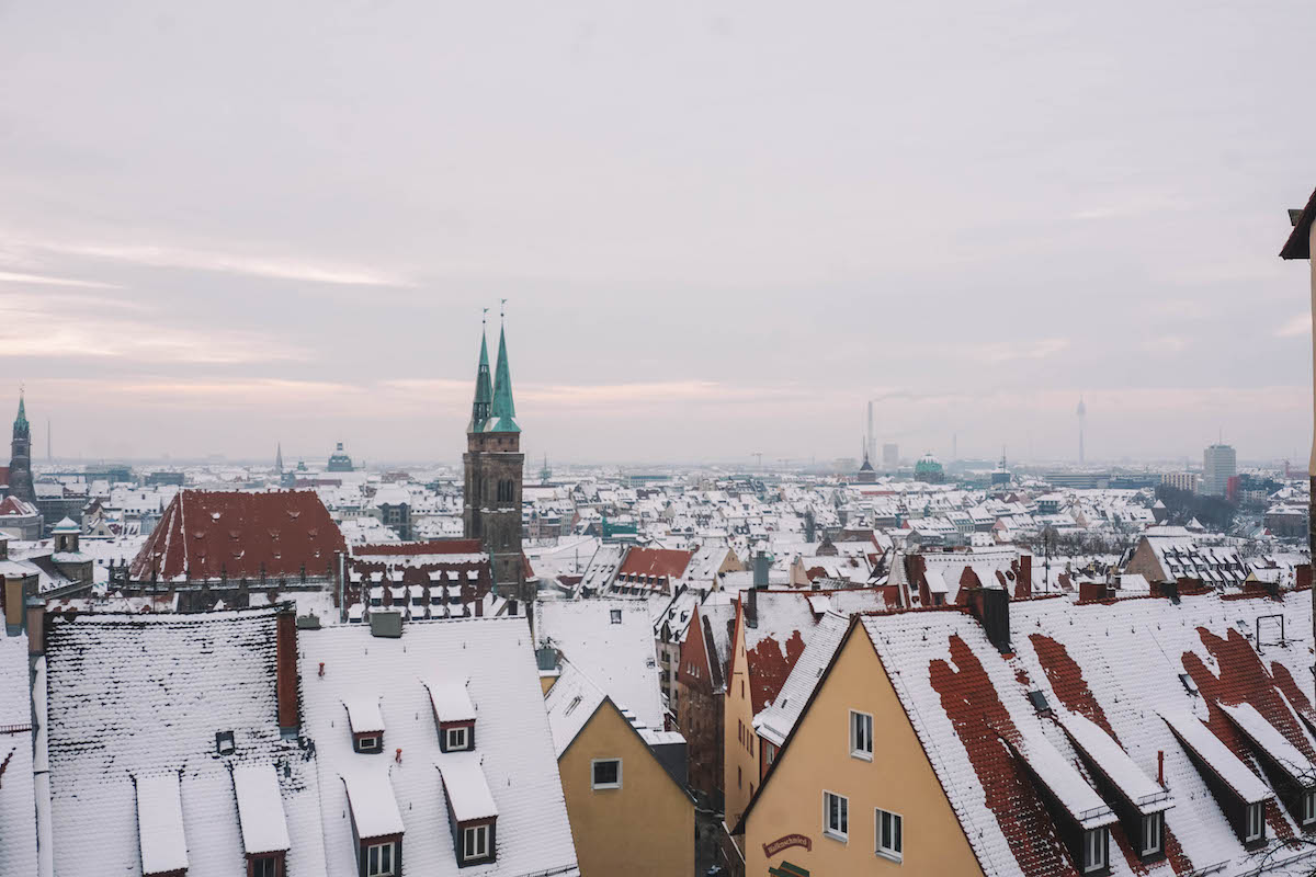 The skyline of Old Town Nuremberg, covered in snow. 