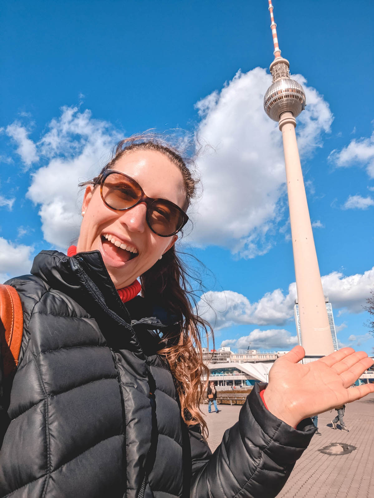 A woman smiling in front of Berlin's TV tower