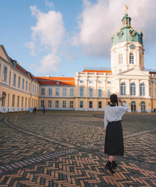 Woman standing in inner courtyard of Charlottenburg Palace