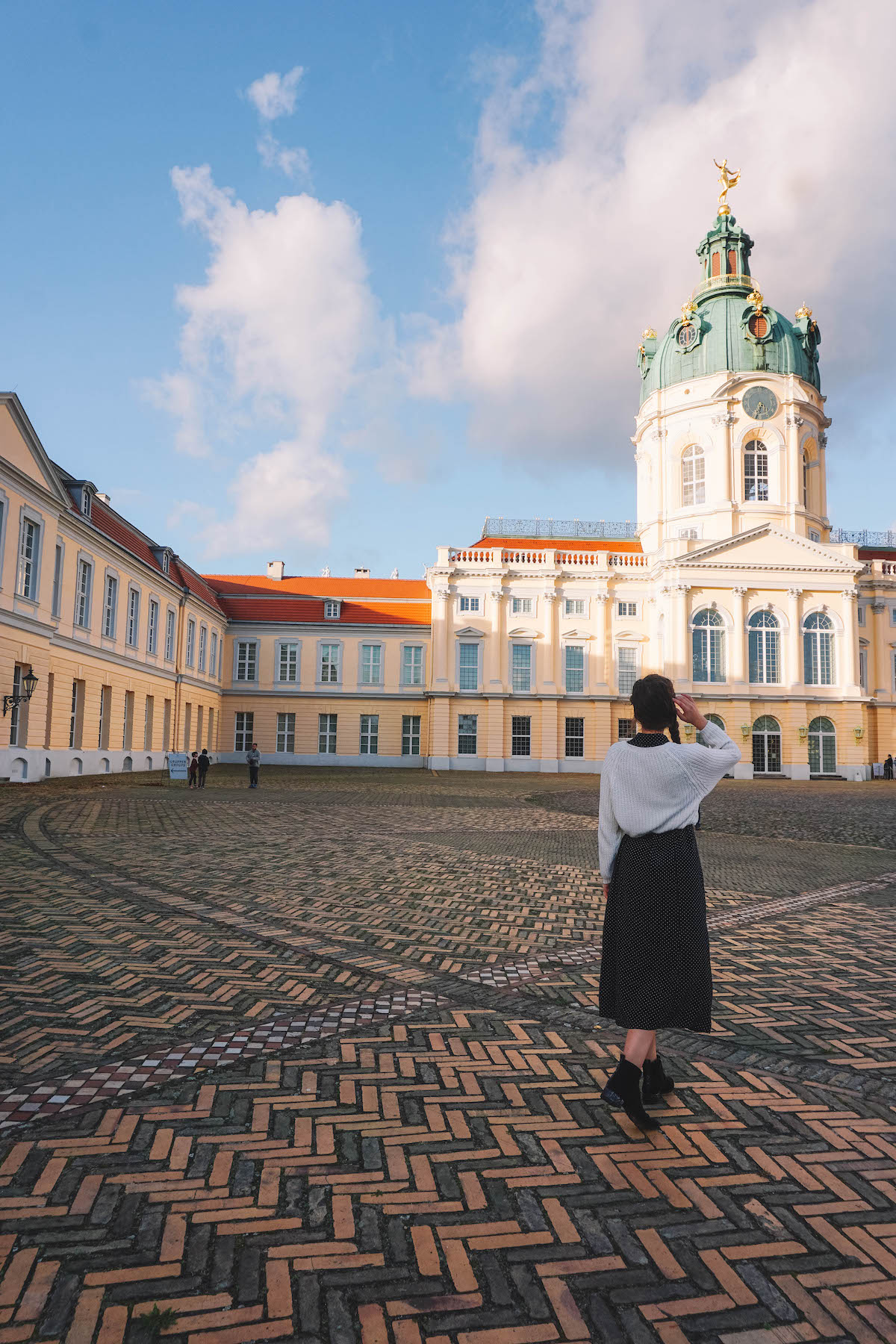 Woman standing in inner courtyard of Charlottenburg Palace