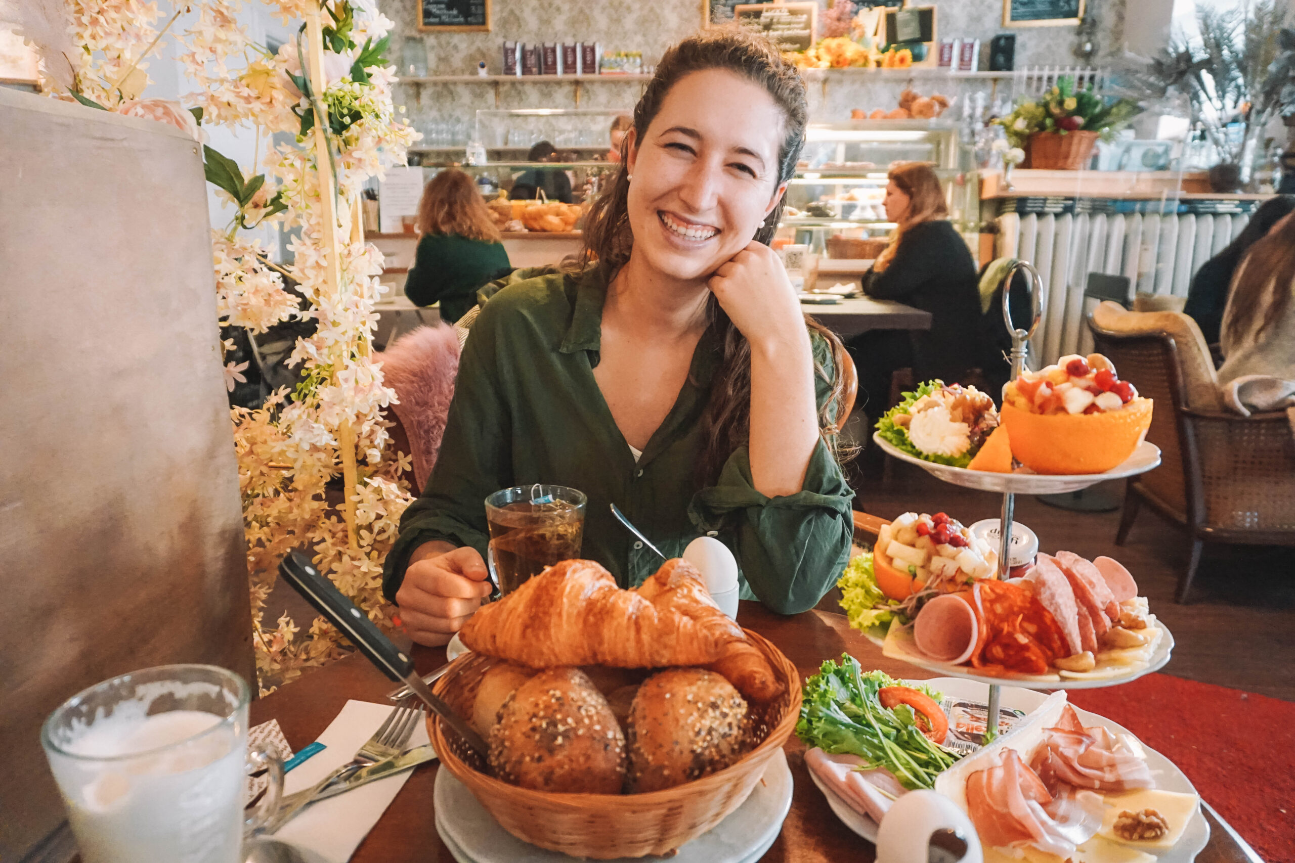 Woman smiling over brunch in Charlottenburg 