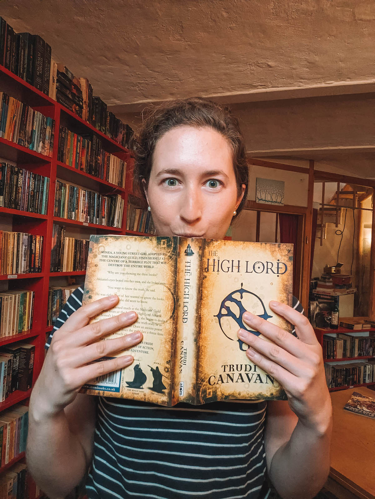 Woman holding book in front of her face