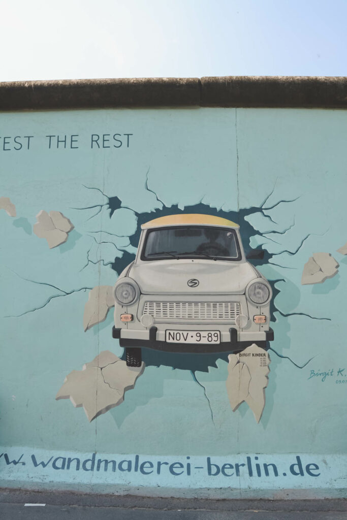 Painting of Trabi bursting through wall at East Side Gallery. 