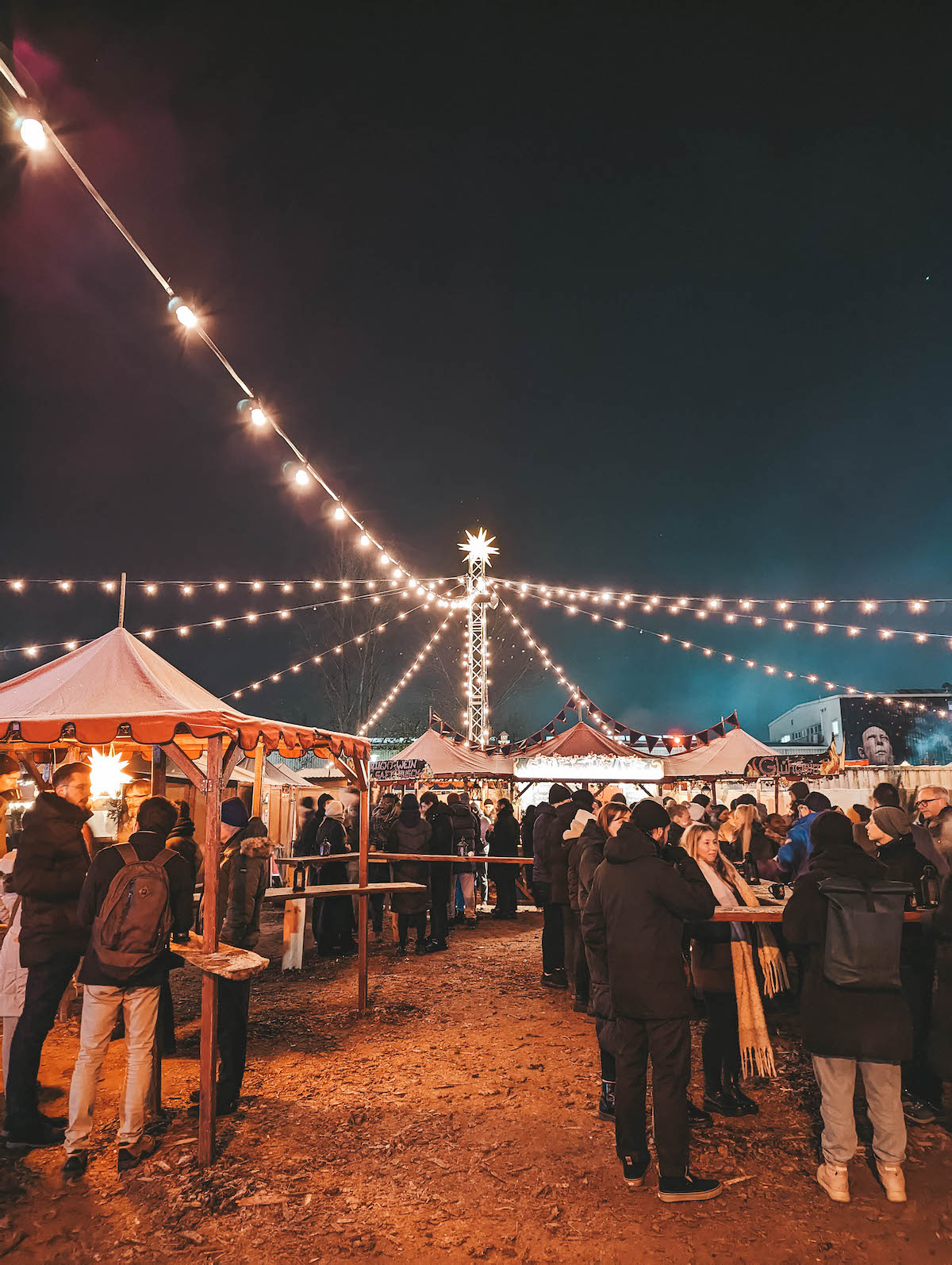Stalls lit up with string lights at the Historic Christmas Market at the RAW Compound. 