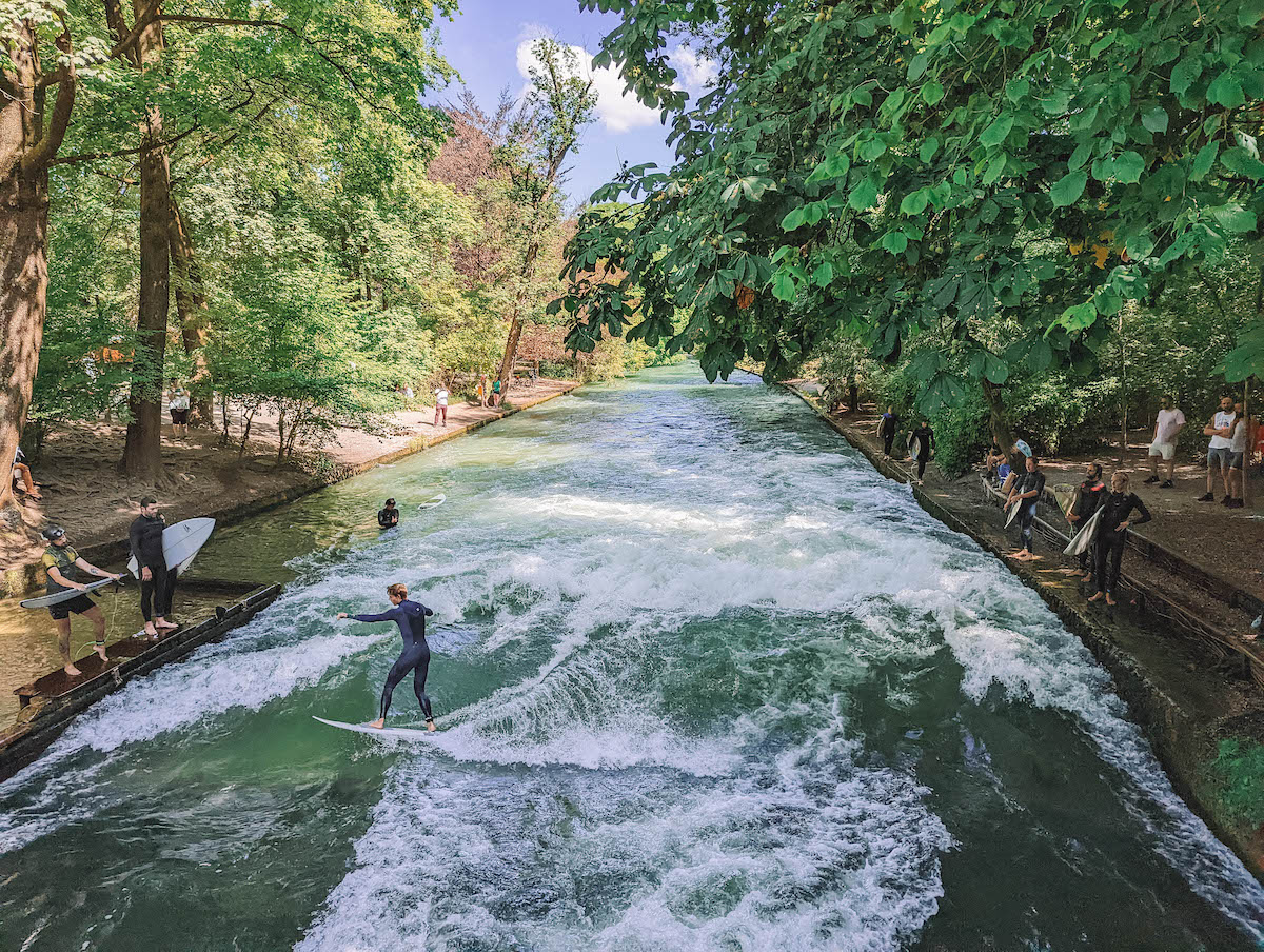 Surfers riding the waves at the Eisbach in Munich