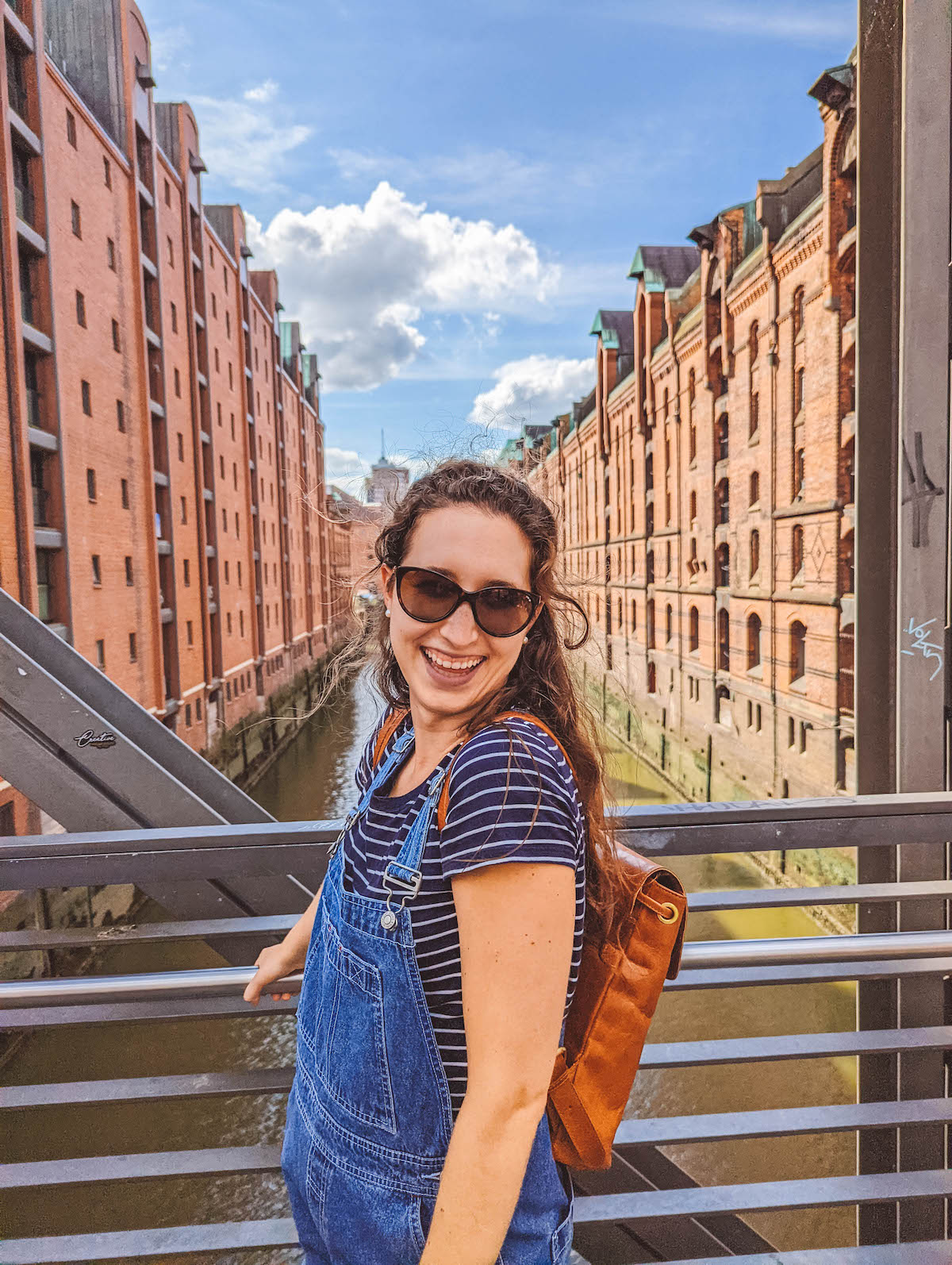 A woman smiling on a bridge in Hamburg's Speicherstadt 
