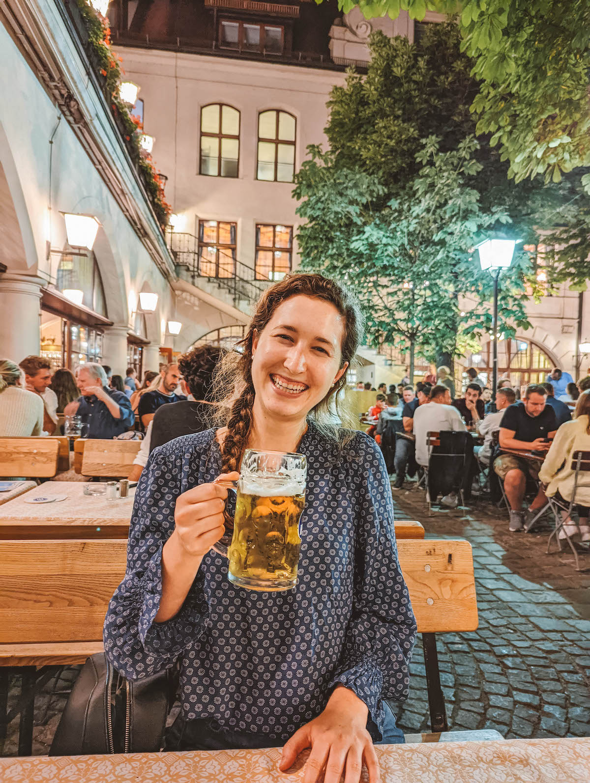 Woman cheersing with a liter of beer at the Hofbräuhaus in Munich, Germany. 