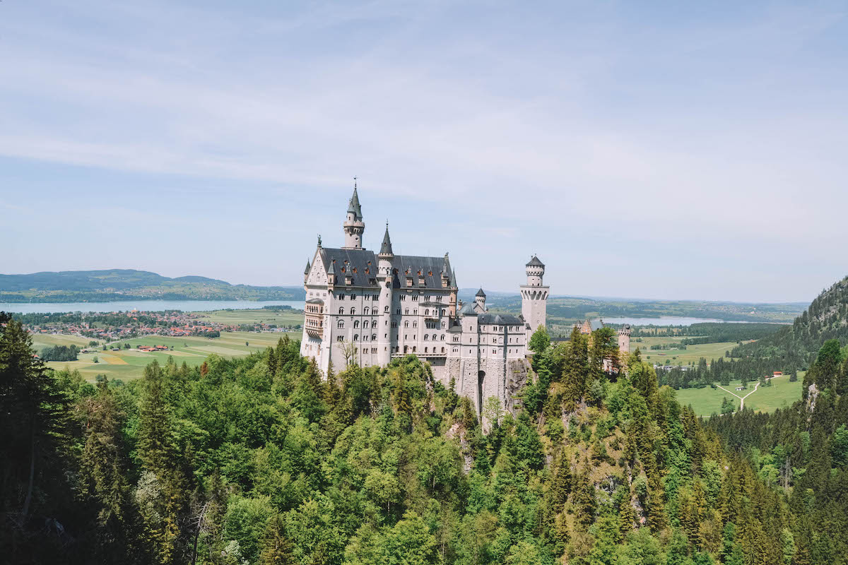 Neuschwanstein Castle, seen from a bridge on a sunny day. 