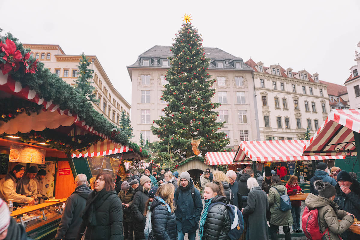 Red and white striped stalls and a Christmas tree at the Christmas market in Leipzig