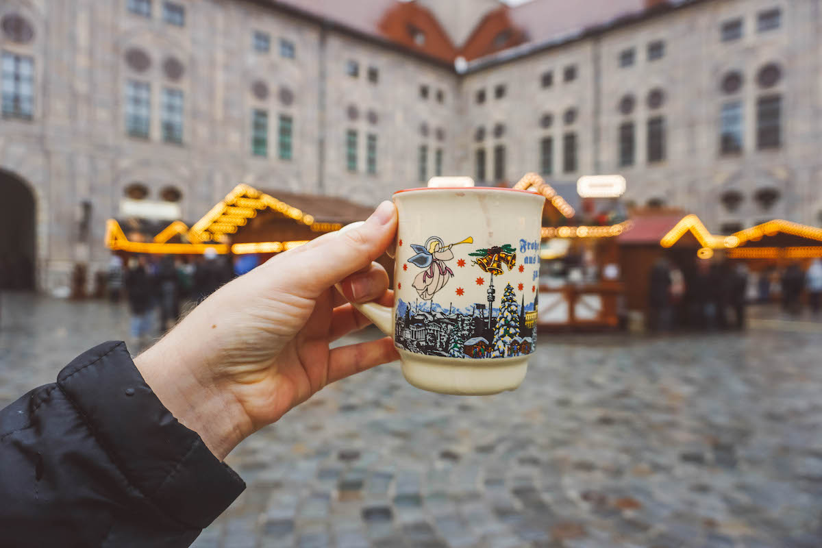 A Munich Christmas market mug being beld aloft 