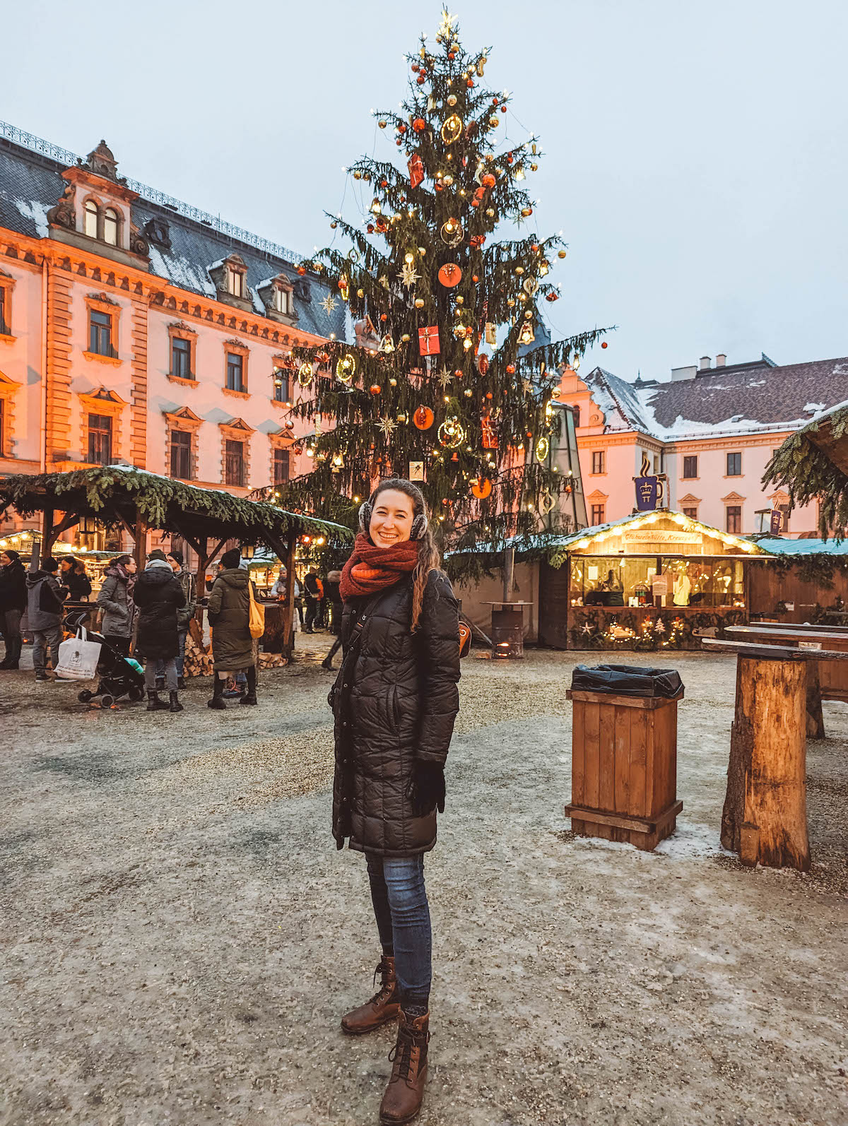 Woman standing in front of Christmas tree at Schloss Thurn und Taxis Christmas market 