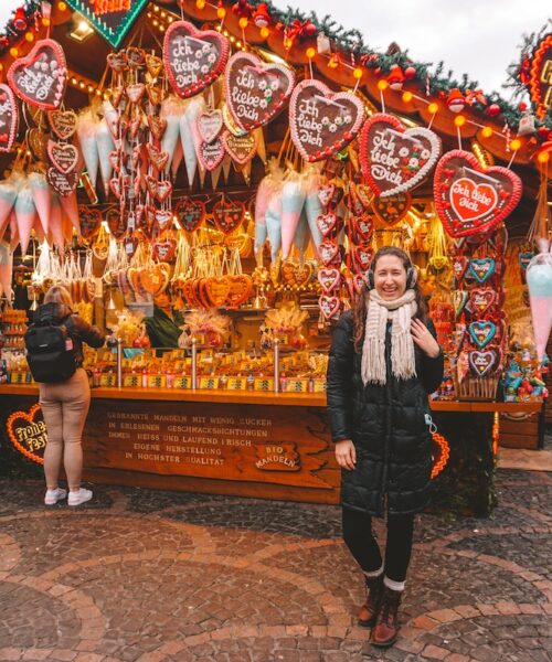 Woman smiling in front of gingerbread stall