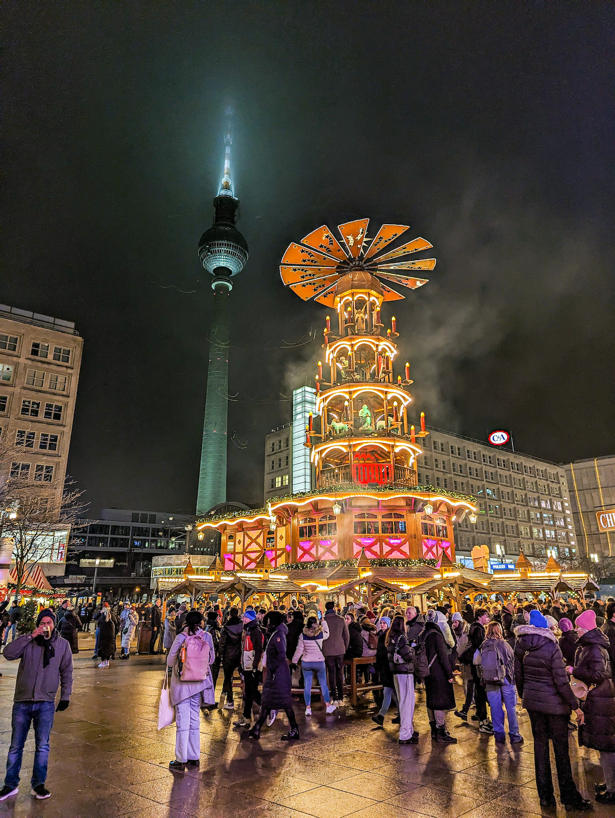 The Christmas pyramid at the Alexanderplatz Christmas market, at night. The TV tower is in the background. 