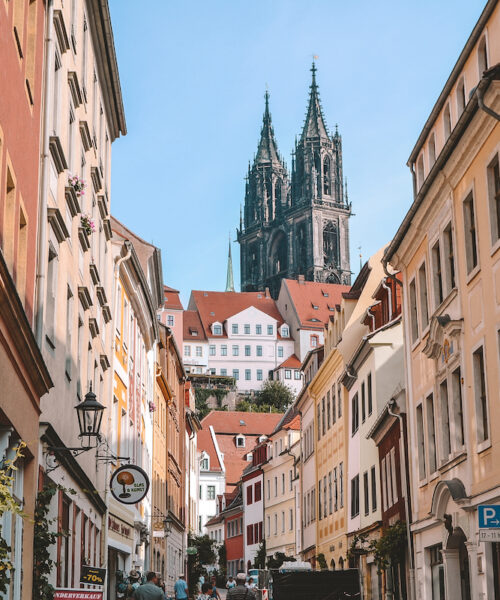 A street in Meissen, with Albrechtsburg Castle seen at the top of the hill.