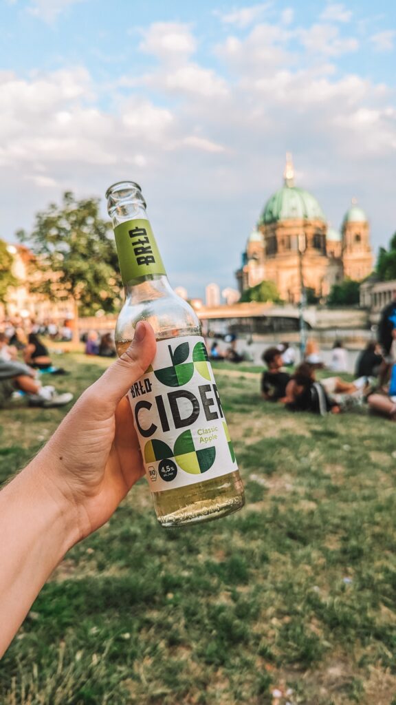 BRLO cider being held aloft at James Simon Park
