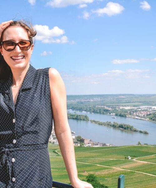 Woman smiling, with Rüdesheim am Rhein in background