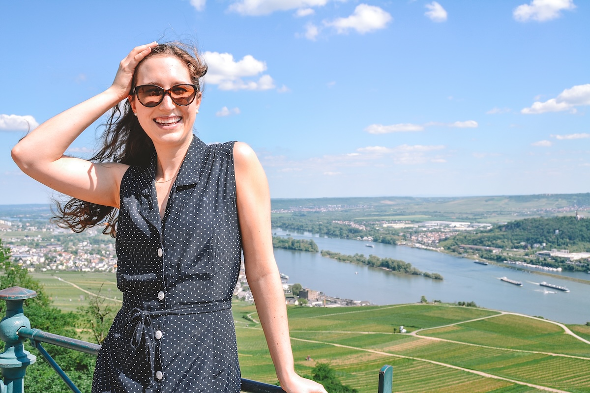 Woman smiling, with Rüdesheim am Rhein in background