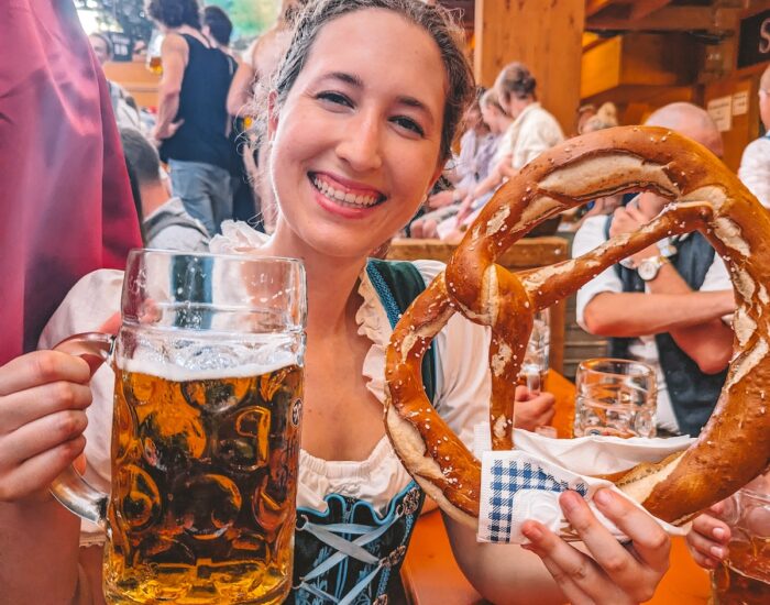 Woman holding beer and pretzel at Oktoberfest