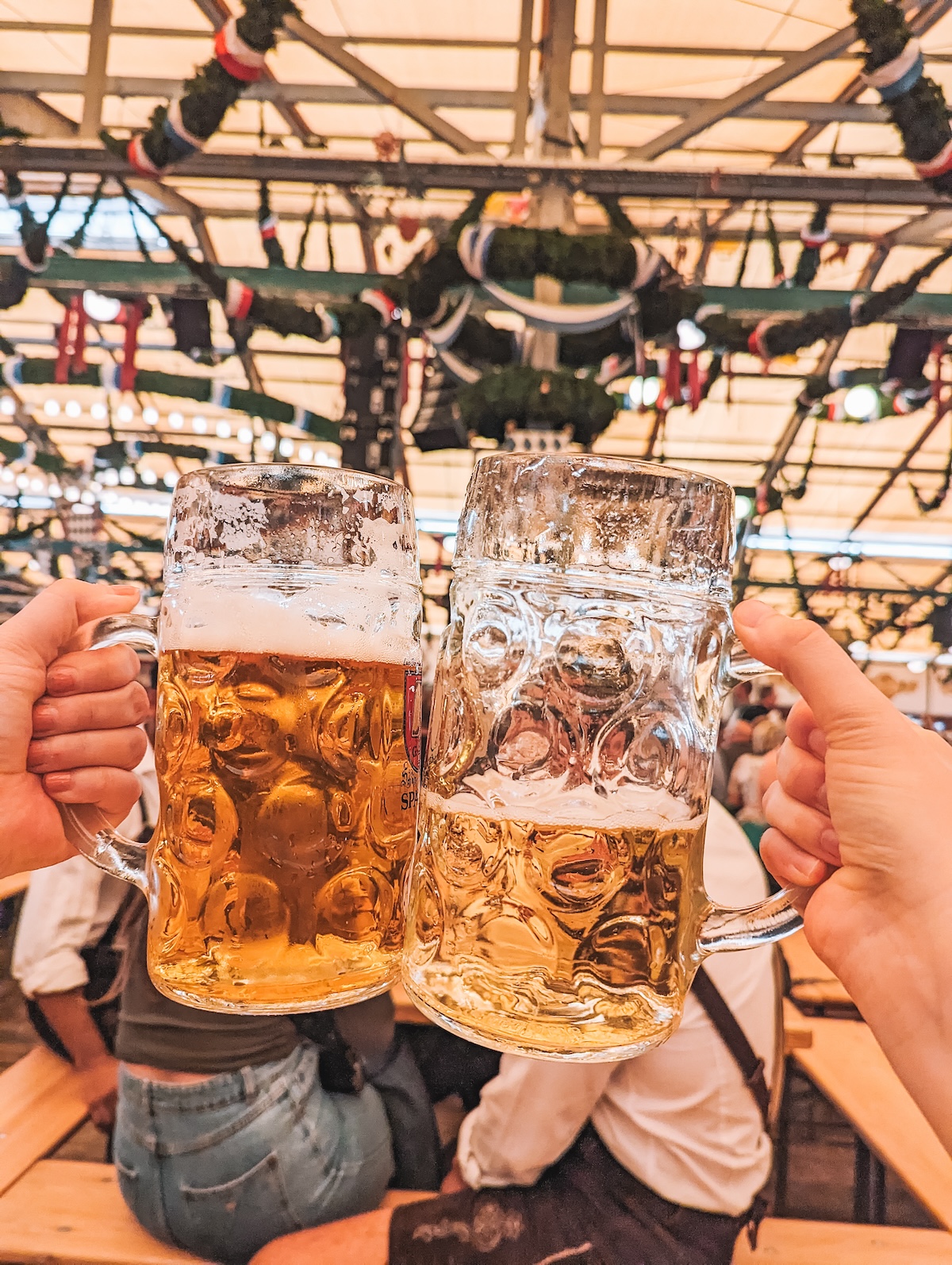 Spaten beers held aloft inside beer tent