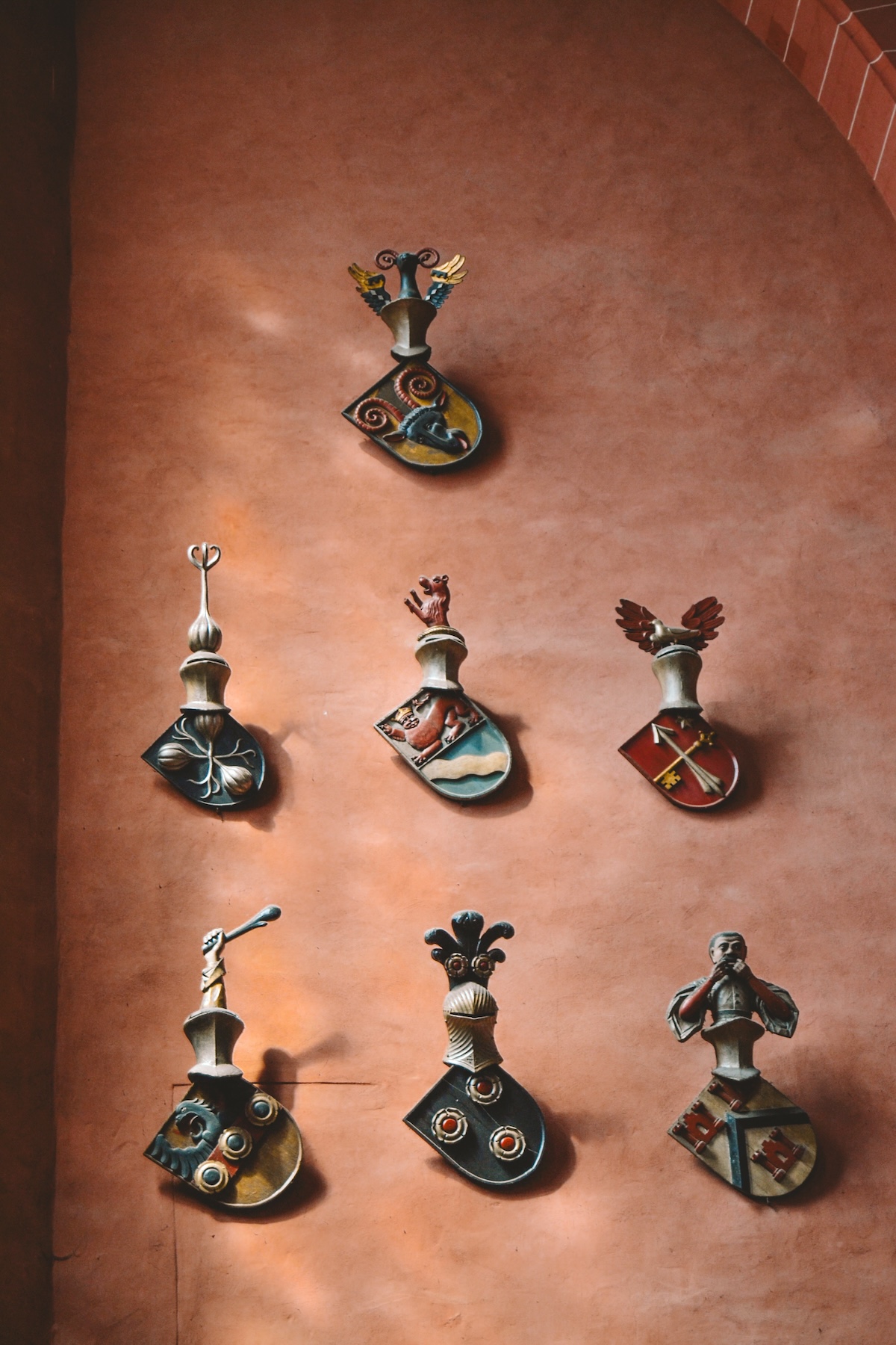 Family shields hung on a wall inside the Frankfurt Cathedral.