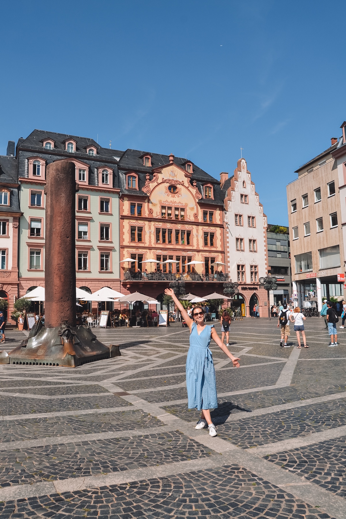 Woman smiling at the Mainz Markt square. 