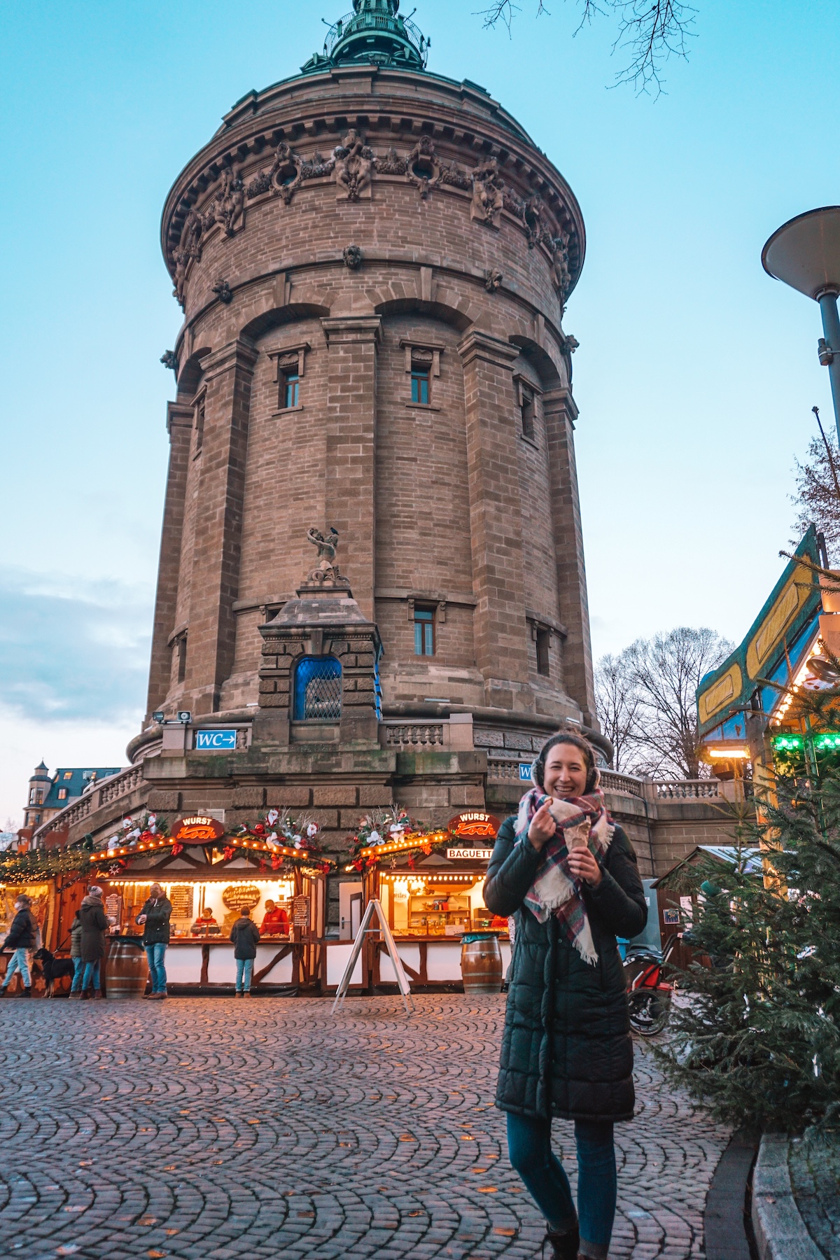 Woman smiling in front of Mannheim water tower