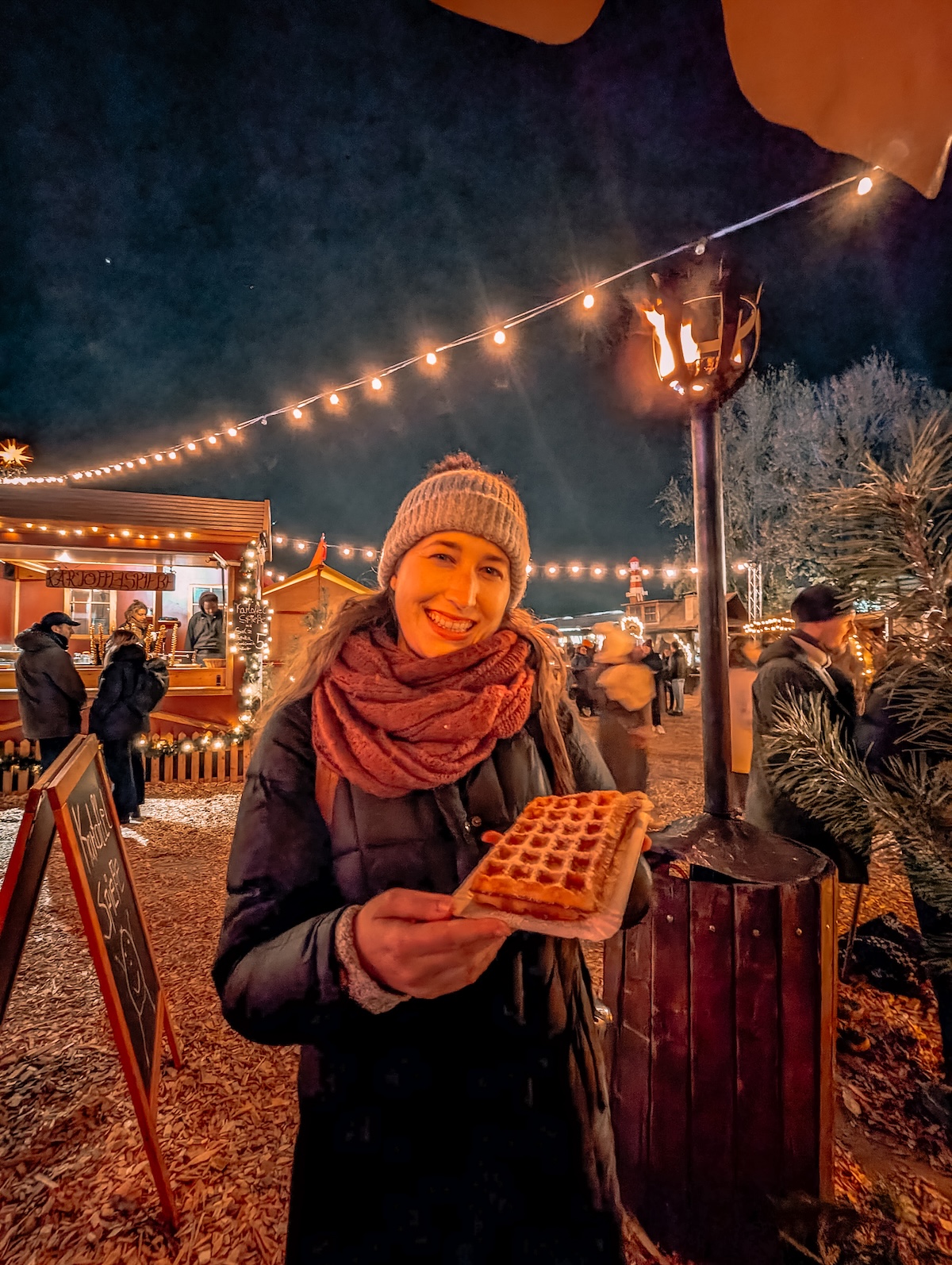 Woman holding waffle at Christmas market