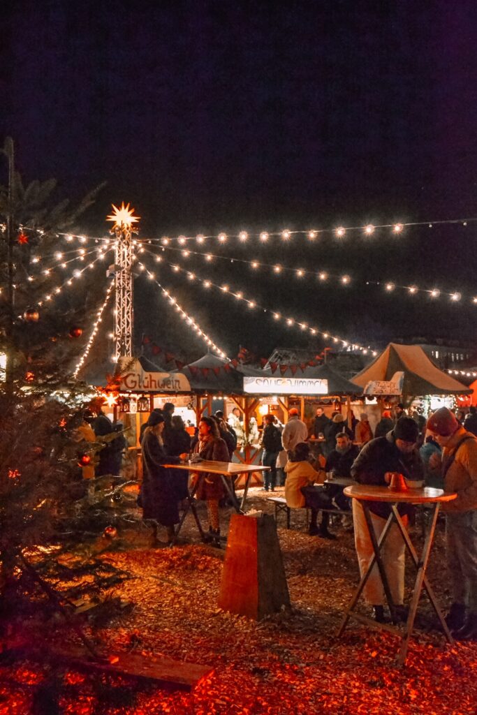 String lights strung over Christmas market tents in Friedrichshain