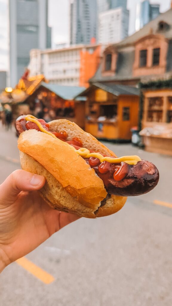 A bratwurst held aloft