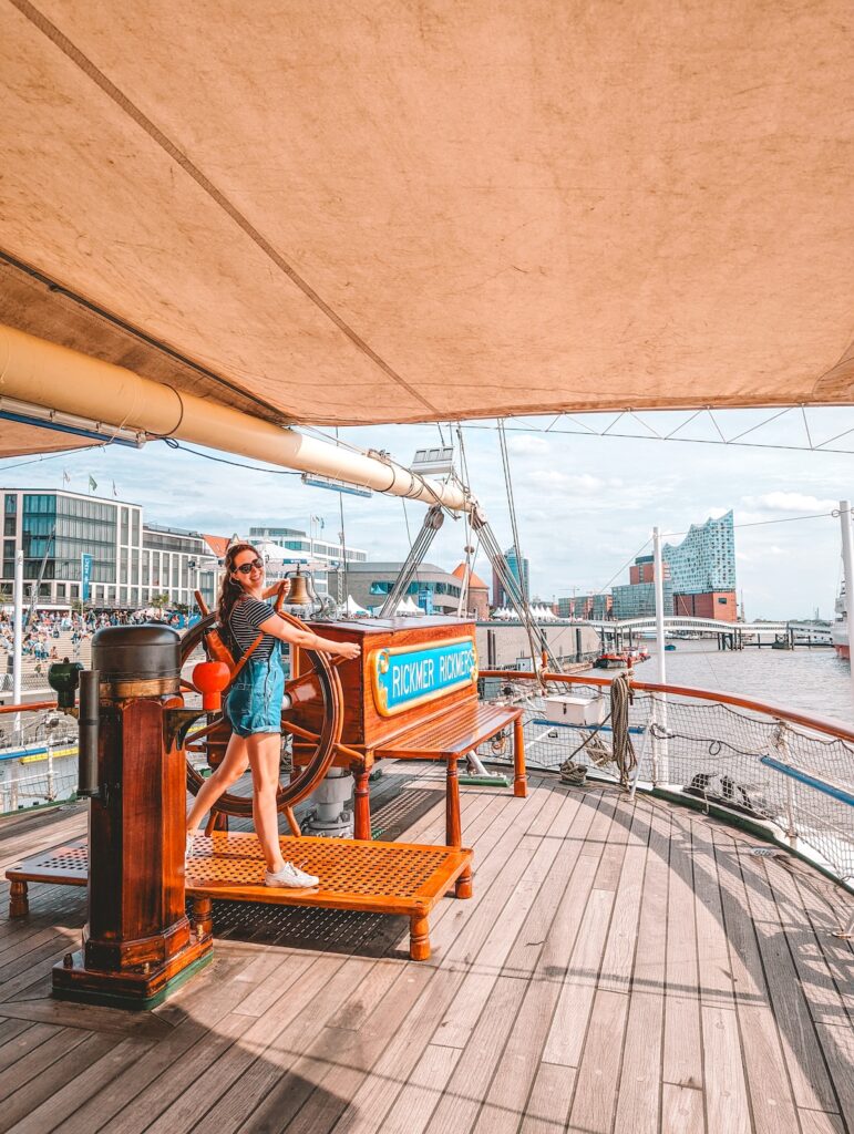 Woman standing at the helm of the Rickmer Rickmers ship in Hamburg.