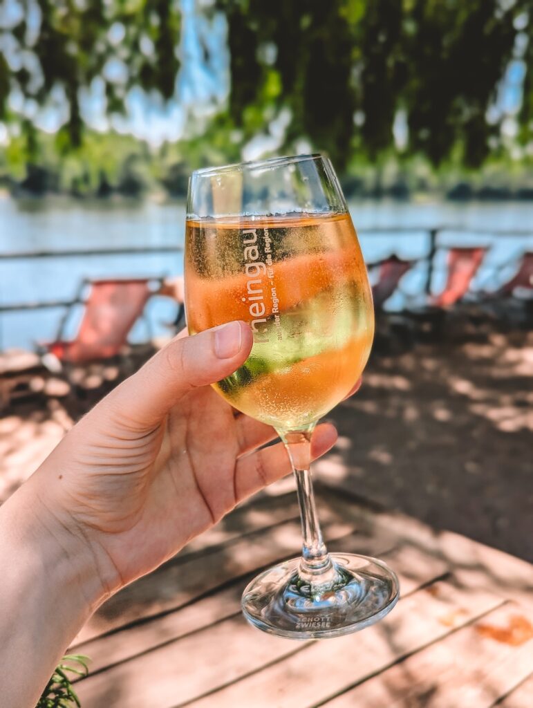 a glass of Riesling being held aloft