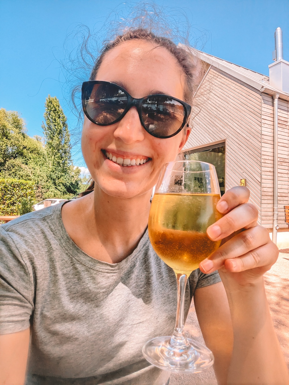 woman holding up a glass of Riesling