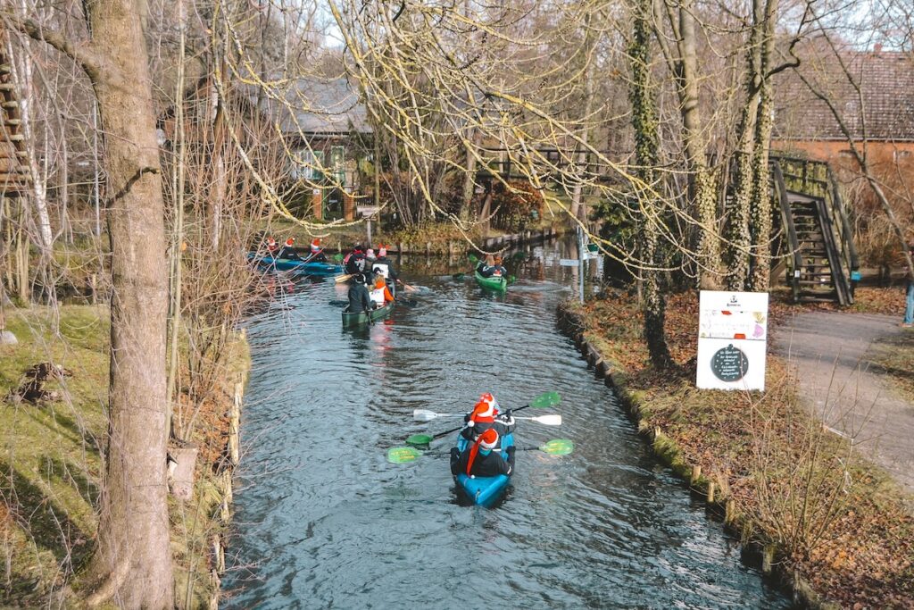 kayakers in Spreewald wearing Santa hats